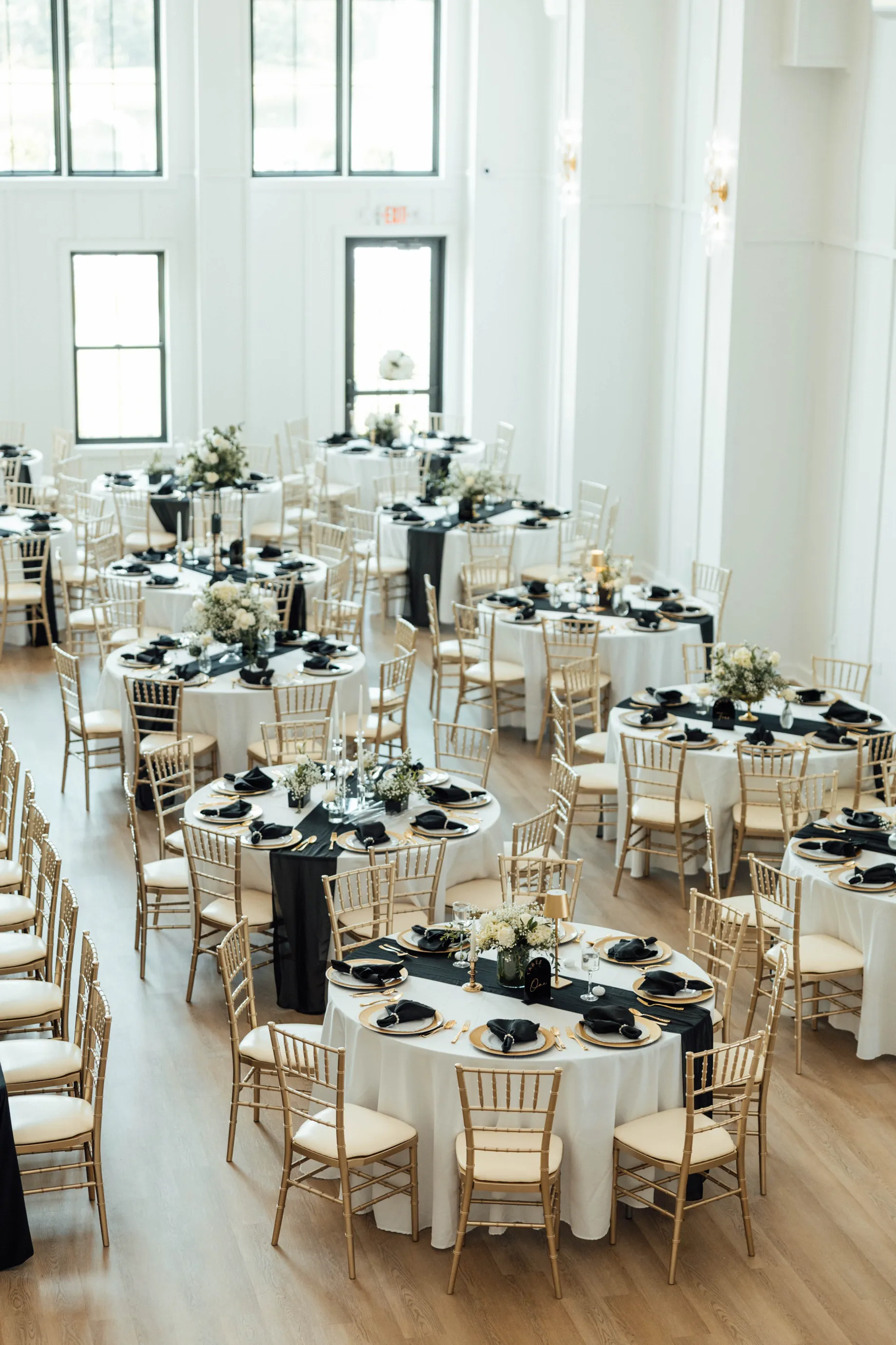 Wedding reception hall decorated with elegant table settings at North Rail event venue